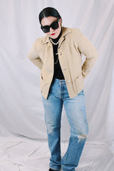 Women's vintage 1960's Union Made, Genuine Heeksuede Made in Holland label long sleeve short length tan colored suede button up lightweight jacket. Two front pockets and pink liner.