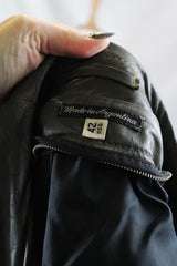 Men's or women's vintage 1970's Made in Argentina label knee length dark grey colored leather trench coat with double lapel and button closure.