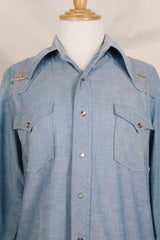 Men's vintage 1970's long sleeve chambray denim shirt with colored embroidery in the front and back.