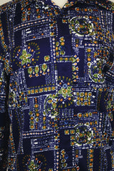 Men's or women's vintage 1970's Jantzen 100, Made in USA label long sleeve button up shirt in vibrant navy blue with all over orange, green, and white floral print.
