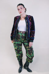 Women's vintage 1980's Saxton Hall, Made in Japan label long sleeve black velvet jacket with all over multicolored print and gold buttons.