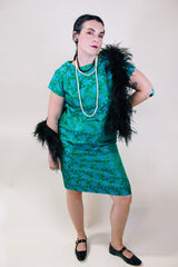 Women's vintage 1960's short sleeve midi length green and blue stain dress. Subtle floral print and scalloped waist. Zipper in the back.