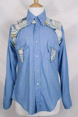 Men's vintage 1970's long sleeve button up blue colored shirt with patchwork detail throughout. Pearl snapper buttons up the front.