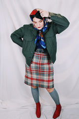 Women's or men's vintage cropped army jacket in a dark green grey wool material. Has a button closure and two front chest pockets.