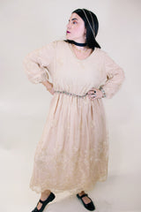Women's vintage 1960's ankle length cream dress with lace overlay that has gold metallic detail. Beaded belt and beaded cuffs.