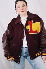 Men's or women's vintage 1980's Settlemien's label long sleeve maroon varsity letterman jacket with a yellow patch and trim.