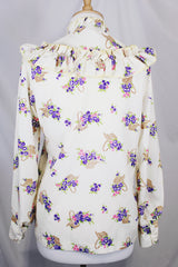 Women's vintage 1980's Val Lanne's label long sleeve button up blouse with ruffle details and pearl buttons. Cream color with all over purple floral print.