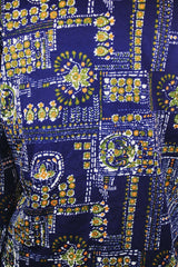 Men's or women's vintage 1970's Jantzen 100, Made in USA label long sleeve button up shirt in vibrant navy blue with all over orange, green, and white floral print.