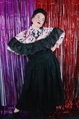 Women's vintage 1980's sleeveless off the shoulder ankle length black colored prom dress. Has a ruffled collar with all over silver metallic polka dots.