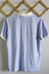 Women's or men's vintage 1980's Izod Lacoste label short sleeve polo tee with white collar and trim, three button closure, side slits.