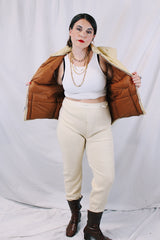 Women's or men's vintage 1970's A & M Industries, Seattle, Washington label sleeveless zip up puffer vest. Cream colored exterior, brown colored interior.