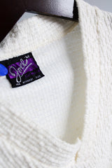 Women's or men's vintage 1970's Joel, Cal Made label short sleeve white top with a V shaped neckline and a chest pocket in textured acrylic material.