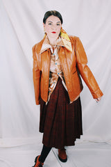 Men's or women's vintage 1970's The Leather Shop, Sears The Men's Store label long sleeve short length camel brown colored leather zip up jacket.