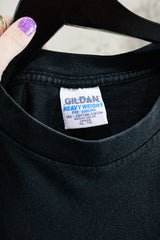 Women's or men's vintage 1997 Gildan Heavyweight, Made in Canada label short sleeve black The Kinks' Ray Davies The Storyteller tour tee with colored graphic and text on front and back.