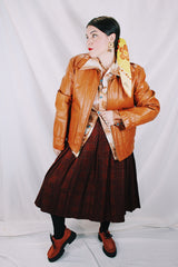 Men's or women's vintage 1970's The Leather Shop, Sears The Men's Store label long sleeve short length camel brown colored leather zip up jacket.