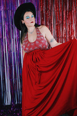 Women's vintage 1980's maxi length sleeveless red polyester halter wrap dress. Has silver sequins and beads on front chest.