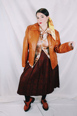 Men's or women's vintage 1970's The Leather Shop, Sears The Men's Store label long sleeve short length camel brown colored leather zip up jacket.