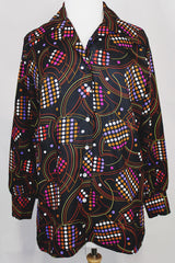 Women's vintage 1970's long sleeve button up blouse in black with all over multi-colored abstract print in a lightweight polyester material.
