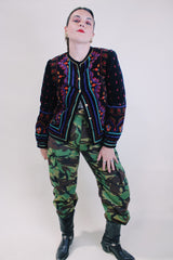 Women's vintage 1980's Saxton Hall, Made in Japan label long sleeve black velvet jacket with all over multicolored print and gold buttons.