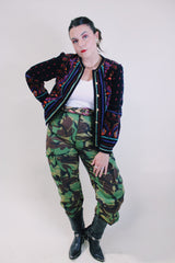 Women's vintage 1980's Saxton Hall, Made in Japan label long sleeve black velvet jacket with all over multicolored print and gold buttons.