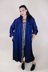 Women's vintage 1960's long sleeve purple satin robe. Long length and shiny material. Chest pocket and two side pockets.