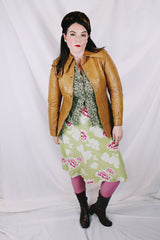 Women's vintage 1970's Made in Belgium label long sleeve light tan colored leather lightweight jacket with silver snap buttons and a dagger collar.