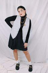 Men's or women's vintage 1960's Issued by Authority of Amalgamated Clothing, Union Made, Workers of America label sleeveless button up waistcoat with grey buttons and two front pockets. Reversible with one solid side and one plaid side