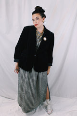 Women's vintage 1970's The Chaus Woman label long sleeve black velvet blazer in a cotton and rayon blend material. One button closure, two pockets, and fully lined.