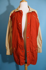 Women's or men's vintage 1980's Aspen label long sleeve zip up lightweight windbreaker jacket in tan and burn orange.