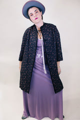 Women's vintage 1960's Helen's Fashion Shoppe, McMinnville, Oregon label long sleeve long length jacket in a black and purple tapestry print.