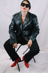 Men's vintage 1980's black genuine leather zip up motorcycle style jacket. All over silver hardware, popper buttons, and and zippers.