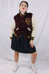 Women's or men's vintage 1982 Nelson's Jackets, Portland, Oregon label long sleeve letterman jacket with a maroon wool body and cream colored leather arms. Yellow stripped trim and popper buttons. Embroidery on chest.