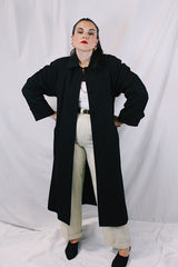 Women's vintage 1990's Nordstrom - Point of View label long sleeve long length black trench coat in a wool material. Fully lined, side pockets, back slit, and shoulder pads.