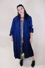 Women's vintage 1960's long sleeve purple satin robe. Long length and shiny material. Chest pocket and two side pockets.