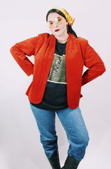 Women's vintage 1970's Deerskin Quality Leathers long sleeve open front lightweight suede leather jacket in a vibrant burnt orange color.