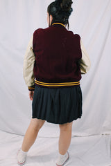 Women's or men's vintage 1982 Nelson's Jackets, Portland, Oregon label long sleeve letterman jacket with a maroon wool body and cream colored leather arms. Yellow stripped trim and popper buttons. Embroidery on chest.