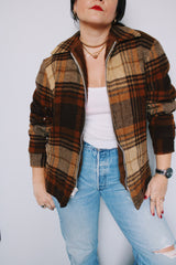 Women's vintage 1970's Woolrich, Made in USA label long sleeve zip up plaid shacket in a wool blend material. All over brown plaid print. Has pockets and faux fur liner.