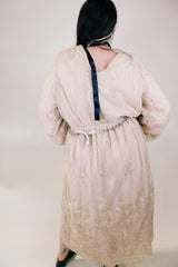 Women's vintage 1960's ankle length cream dress with lace overlay that has gold metallic detail. Beaded belt and beaded cuffs.