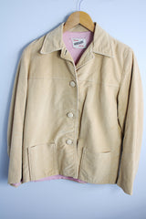 Women's vintage 1960's Union Made, Genuine Heeksuede Made in Holland label long sleeve short length tan colored suede button up lightweight jacket. Two front pockets and pink liner.