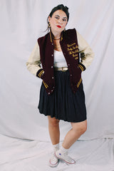 Women's or men's vintage 1982 Nelson's Jackets, Portland, Oregon label long sleeve letterman jacket with a maroon wool body and cream colored leather arms. Yellow stripped trim and popper buttons. Embroidery on chest.