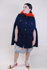 Women's vintage 1960's navy blue wool material poncho with slits for arms, gold hardware and gold buttons. Fully lined.