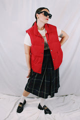 Men's or women's vintage 1980's Woolrich, Made in USA label sleeveless cherry red puffer vest. Popper buttons up the front and two pockets.
