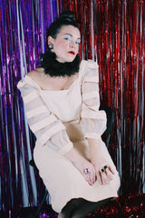 Women's vintage 1980's Made in USA label long sleeve mini length light tan colored dress.