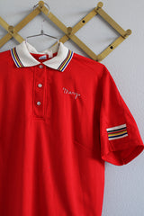 Women's vintage 1970's Hilton, Made in USA label short sleeve red half button closure polo bowling shirt with white striped collar and trim.
