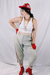 Men's vintage 1940's Rawlings, St. Louis label capri length baseball pants in grey wool material with red stripe piping along each side of leg.