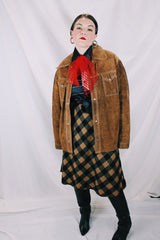 Men's or women's vintage 1970's long sleeve light brown tan colored suede jacket. Has silver snap buttons, contrast stitching, and a dagger collar.