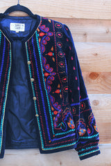 Women's vintage 1980's Saxton Hall, Made in Japan label long sleeve black velvet jacket with all over multicolored print and gold buttons.