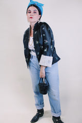 Women's vintage 1960's satin reversible robe jacket in black and grey with all over embroidered print. Mandarin collar and fabric buttons.