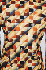 Women's vintage 1970's long sleeve button up shirt with dagger collar and all over brown and orange abstract print.