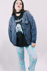 Women's vintage 1990's long sleeve acrylic knit button up cardigan in purple and blue colors with a flower pin.
